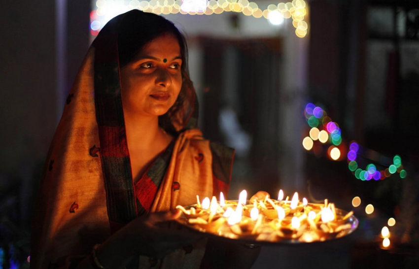 women with diwali lamps